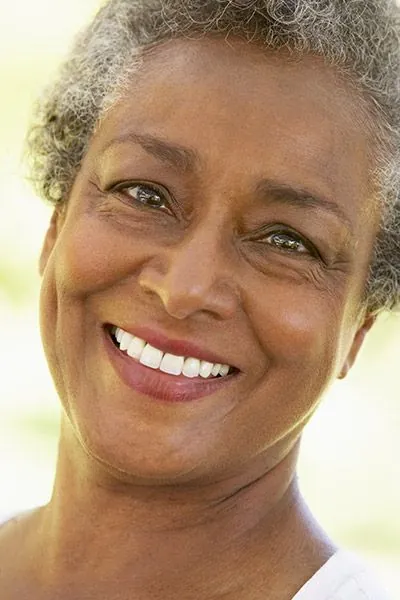 woman smiling big after getting her new dentures from Jay Zimmerman Dentistry