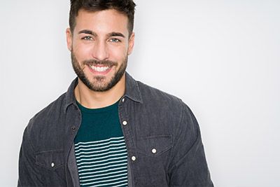 man showing off his smile after getting a smile makeover at Jay Zimmerman Dentistry