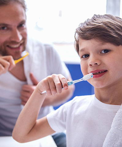 Family brushing teeth at Dr. Jay A. Zimmerman, DMD in Mountainside NJ